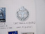 a picture of a bunch of pins and magnets on a piece of paper