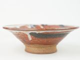a small bowl sitting on top of a white table