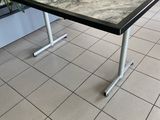 a table that has a bowl on it on a tile floor