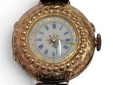 a gold watch with roman numerals on the face