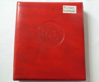 a red leather album with a medallion on the cover