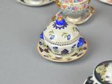 a lot of tea cups and saucers sitting on a table