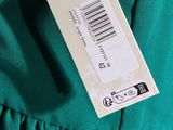 a close up of a green dress with a price tag on it