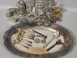 a silver plate with silverware on it on a table
