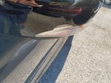 a reflection of a person in the side mirror of a car