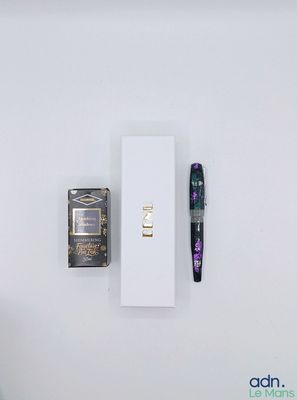 a pen and a box on a white surface