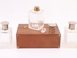 three bottles of perfume sitting on top of a wooden box