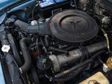 a blue car with a engine in it ' s trunk