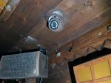 a picture of a room with a ceiling fan and pictures on the wall