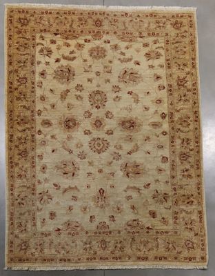 a beige and brown rug with a floral design on it