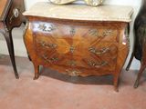 a small chest of drawers with a mirror on top of it