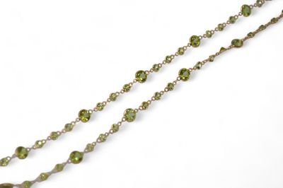 necklace with green stones and silver chain on a white background