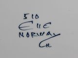 a close up of a white plate with blue writing on it