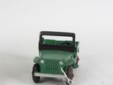 a green toy truck with a black top on a white surface