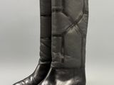 a pair of black leather boots on a white background