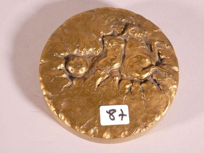 a gold plate with a picture of a man and a woman on it