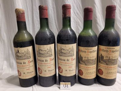 four bottles of wine are lined up on a table