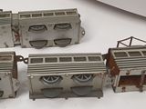 four model trains sitting on a table next to each other
