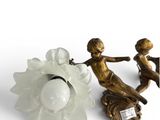 two figurines sitting next to each other on a white surface