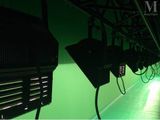 a row of lights that are on a green wall