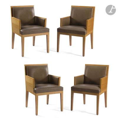 four brown leather chairs with wooden legs and arms