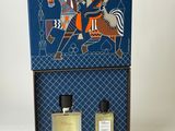 an image of two bottles of perfume sitting on top of a box