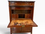 an old wooden desk with marble top and drawers