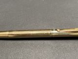 a close up of a pen sitting on top of a table