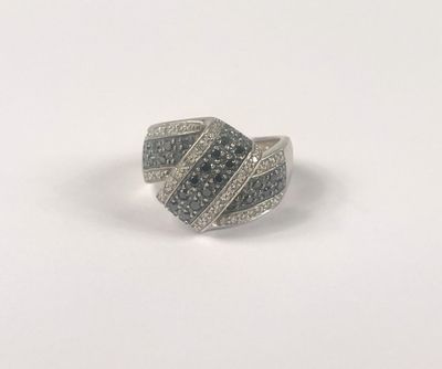 a close up of a silver ring with black and white diamonds