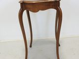 a small table with a wooden top on a white floor