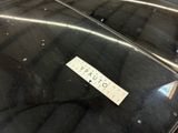 a sticker on the hood of a car that is parked