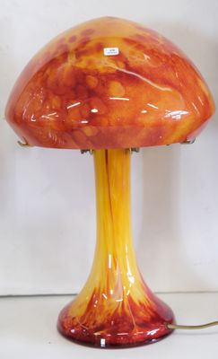 a red and yellow mushroom shaped lamp on a table