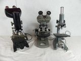 three microscopes that are sitting on a table