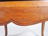 a close up of a wooden table with writing on it