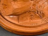 a close up of a wooden statue of a man with a beard