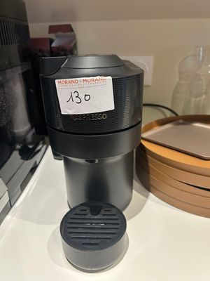 a coffee maker sitting on a counter next to a microwave