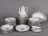 many plates and cups and a pitcher on the table