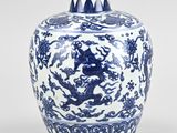 blue and white vase with a dragon on the lid