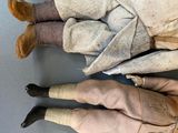 three dolls of different sizes are sitting on a table