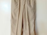 a close up of a pair of beige pants hanging on a wall