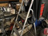 a ladder that is leaning against a wall in a garage
