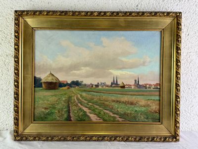 une peinture à l'huile représentant une scène de vie à la ferme, dans un cadre doré, accrochée à un mur blanc