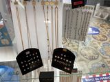 many necklaces and earrings displayed on display in a glass case