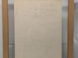 a framed photograph of a piece of paper with writing on it
