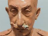 a clay sculpture of a man with a mustache and moustache on his face