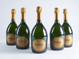 four bottles of champagne are lined up on a white surface