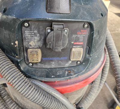 a machine that is sitting on the ground with a hose