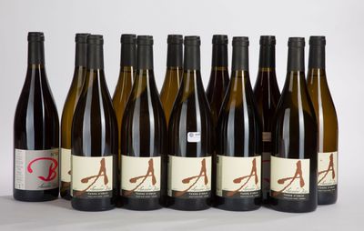 six bottles of wine are lined up in a row on a white surface