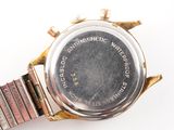 an image of a close up of a wrist watch on a white surface