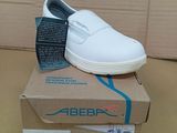 a box with a pair of white shoes on top of it